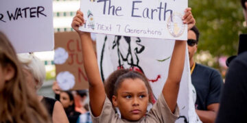 Child holding up a sign at a climate protest