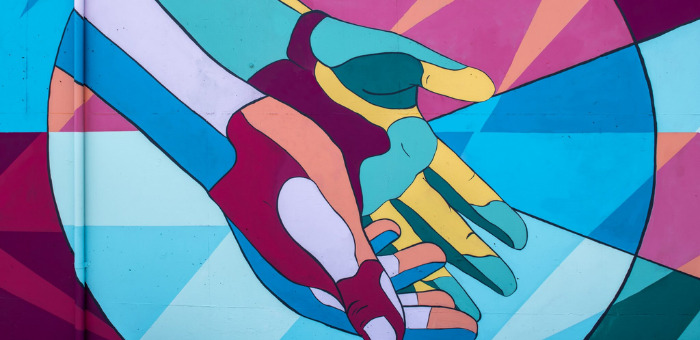 colorful mural of two hands together open palms up