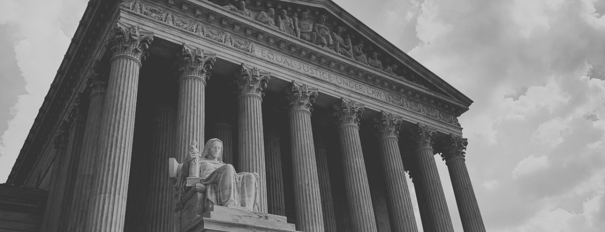 A black and white photo of the Supreme Court building on Capitol Hill